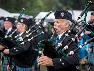Group of Scottish bagpipers with tartan fabric