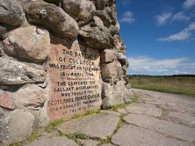 Culloden Battlefield Monument, an iconic stone memorial marking the site of the 1746 battle, set against open fields and a peaceful landscape