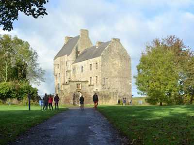 Midhope Castle and its lush green surrounding estate and stone arch by the entrance