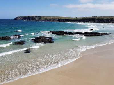 Isle of Harris beach with golden sands and turquoise waters under a bright sunny sky