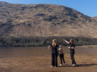Local Highland Explorer Tours guide providing information to tour guests about surroundign scenery in the West Highlands