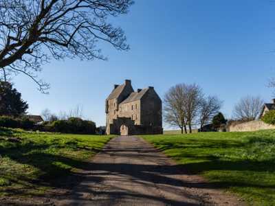 Midhope Castle and its lush green surrounding estate and stone arch by the entrance