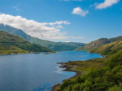 Aerial view of Loch Lomond with blue waters and lush forests along its shores