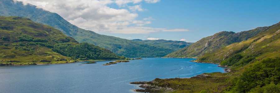 Aerial view of Loch Lomond with blue waters and lush forests along its shores