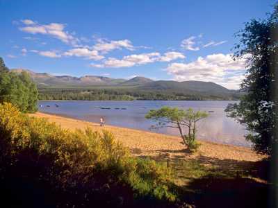 Cairngorms National Park with a tranquil loch surrounded by rolling hills