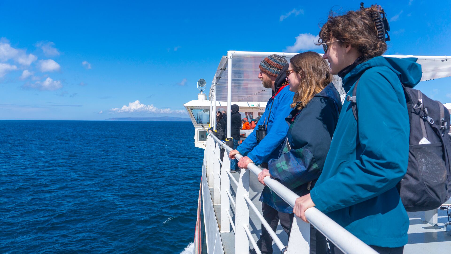 Travellers and Highland Explorer Tours guide enjoying ride on ferry to Orkney