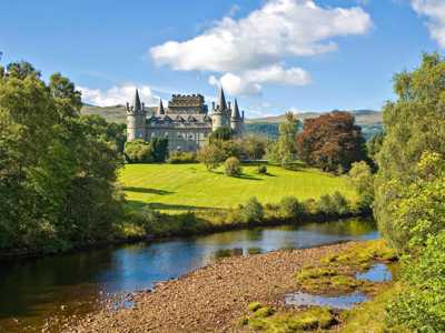 View of majestic Inveraray Castle with gothic arquitecture across River Aray
