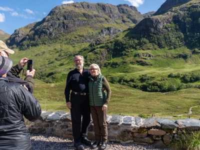 TRavellers takign a photo before the mountain at Glen Coe