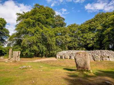 Clava Cairns, a prehistoric burial site near Inverness, featuring ancient stone circles and burial mounds surrounded by trees