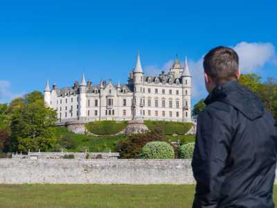 Man admiring views of frensh chateau-style Dunrobin Castle