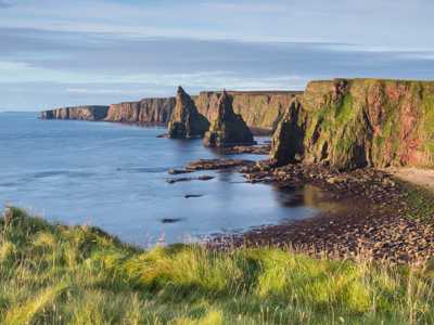 Rocky sea stacks pertruding out of the sea at Duncansby Head