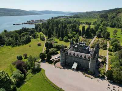 Aerial view of Inveraray Castle with its Gothic architecture with Loch Fyne in the background