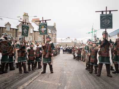 Up Helly Aa Viking parade in Lerwick carrying shields and flags