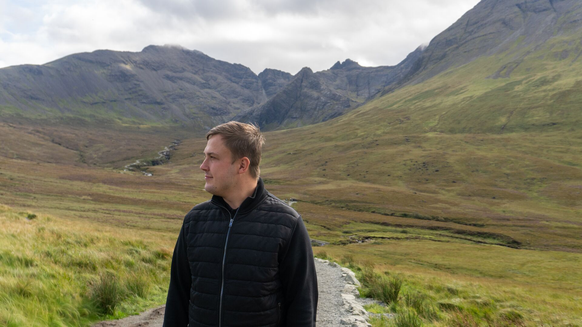 Man exploring the scenic path of the Fairy Pools on the isle of Skye
